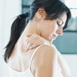 woman massaging neck. Side view, copy space woman massaging neck.